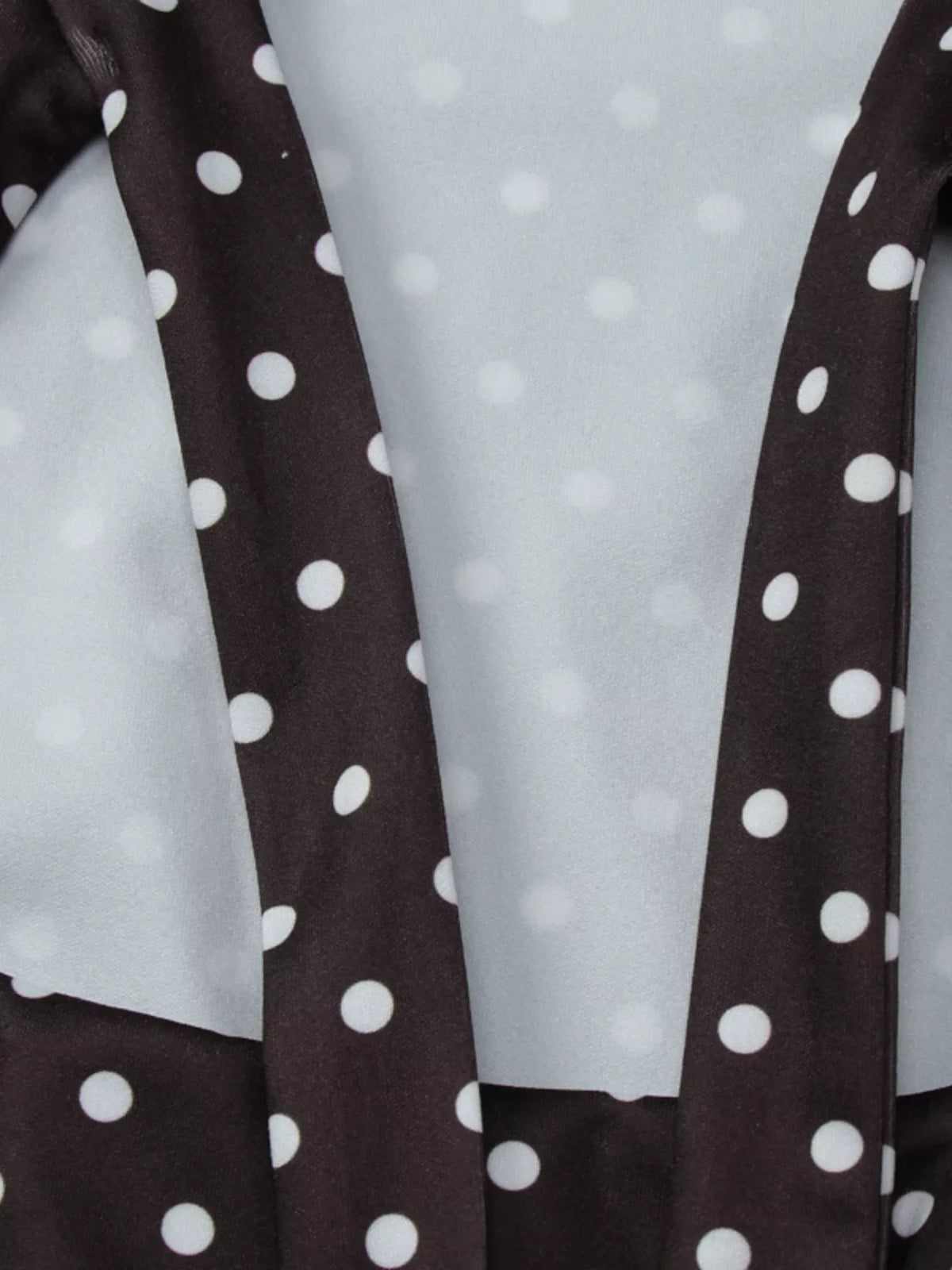 Polka dot cut-out front mini dress by Plush Fashion Hub featuring a stylish design and playful pattern, perfect for trendy occasions.