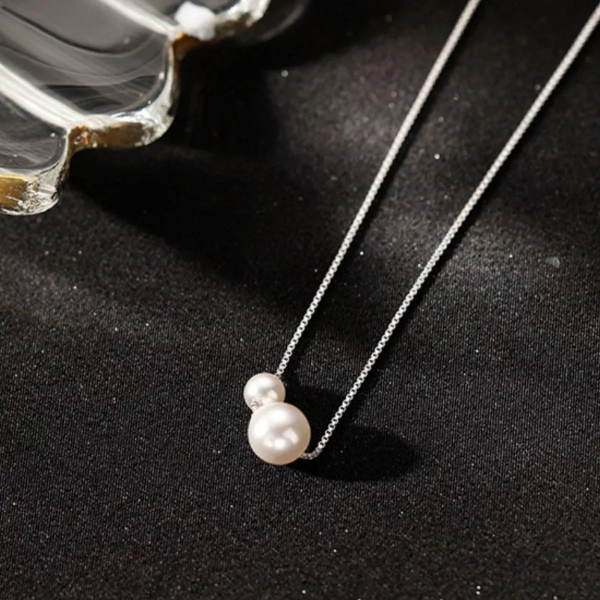 Sterling silver pearl necklace with white pearls and silver clasp, elegant jewelry piece from Plush Fashion Hub