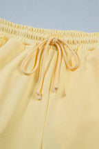 Trendsi half sleeve top and drawstring pants set with rings detail, casual matching ensemble, in soft fabric and neutral tones.