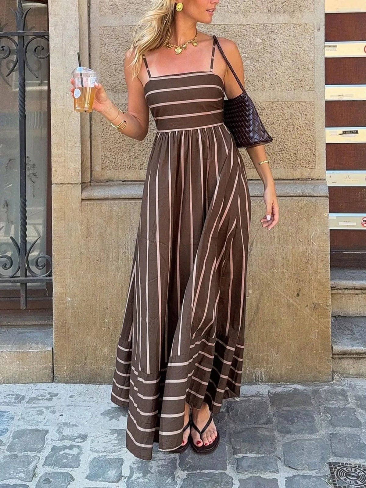Striped cutout back maxi dress by Plush Fashion Hub featuring bold horizontal stripes and a stylish back cutout detail.