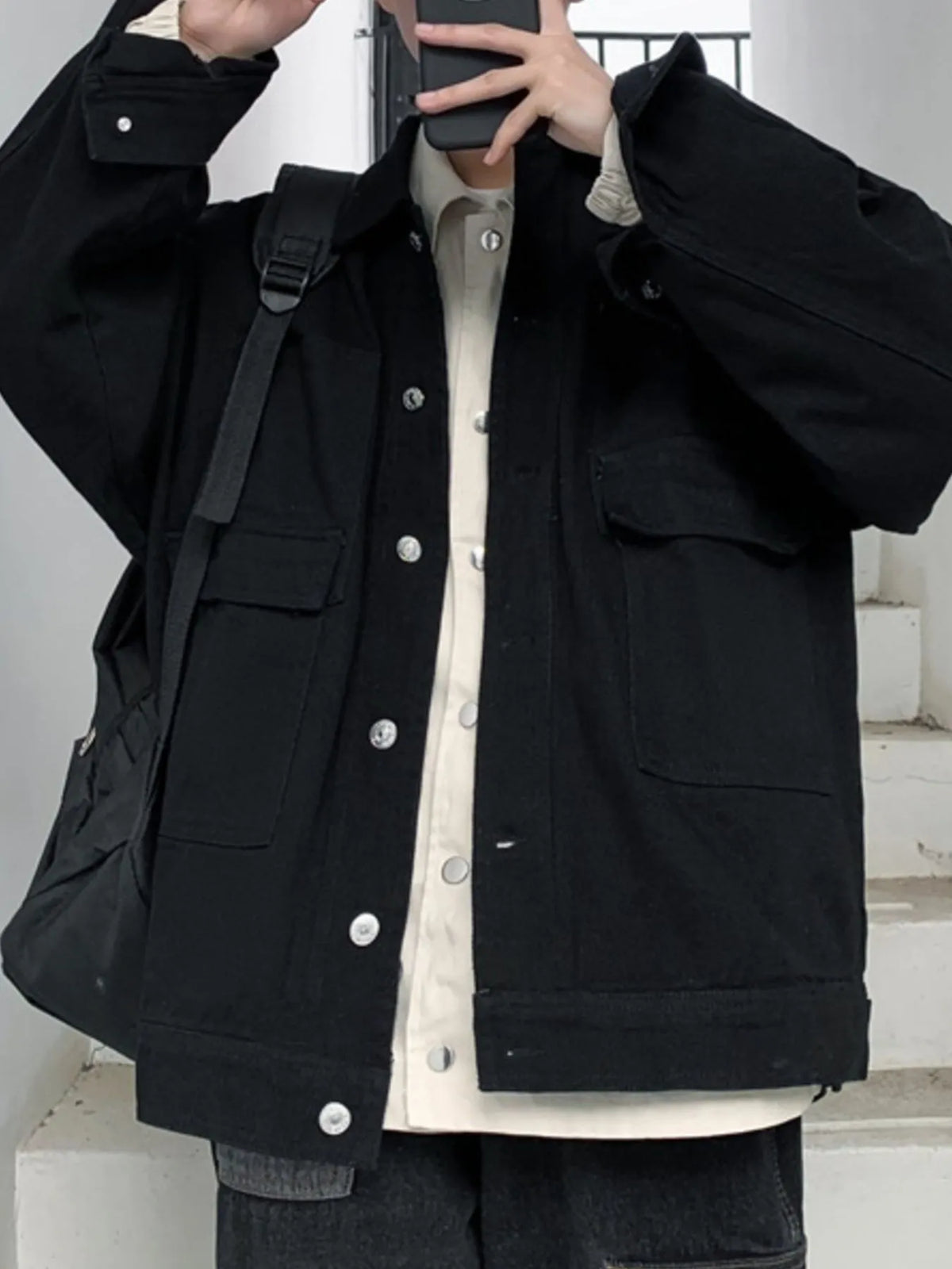 Men's drop shoulder denim jacket by Trendsi, featuring button-up front and classic denim style, shown on a model.