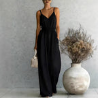 Women's sleeveless wide-leg jumpsuit by FitiqueFit in 5 colors, displayed with front view and flowing fabric.