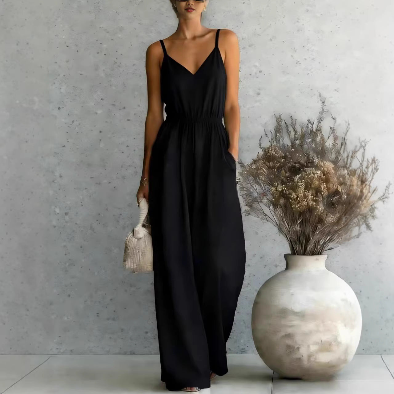 Women's sleeveless wide-leg jumpsuit by FitiqueFit in 5 colors, displayed with front view and flowing fabric.