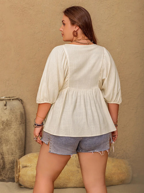 Plus size peplum V-neck half sleeve blouse from Trendsi, featuring a flattering fit and stylish design, shown on a model.