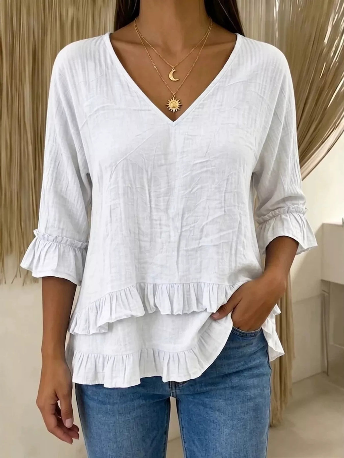 V-neck ruffle sleeve blouse by Trendsi, featuring a flowing fit and stylish ruffle details on the sleeves.
