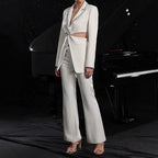 Women's elegant hollow-out long-sleeve suit jacket and pants set by FitiqueFit, featuring a stylish tailored design and intricate detailing.