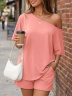 Plus size one-shoulder top and shorts set by Trendsi, casual summer outfit, featuring a stylish off-shoulder top and matching shorts.