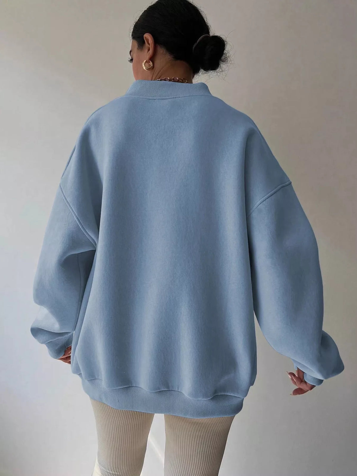 Gray dropped shoulder oversized sweatshirt from Trendsi featuring long sleeves and a relaxed fit, ideal for casual wear.