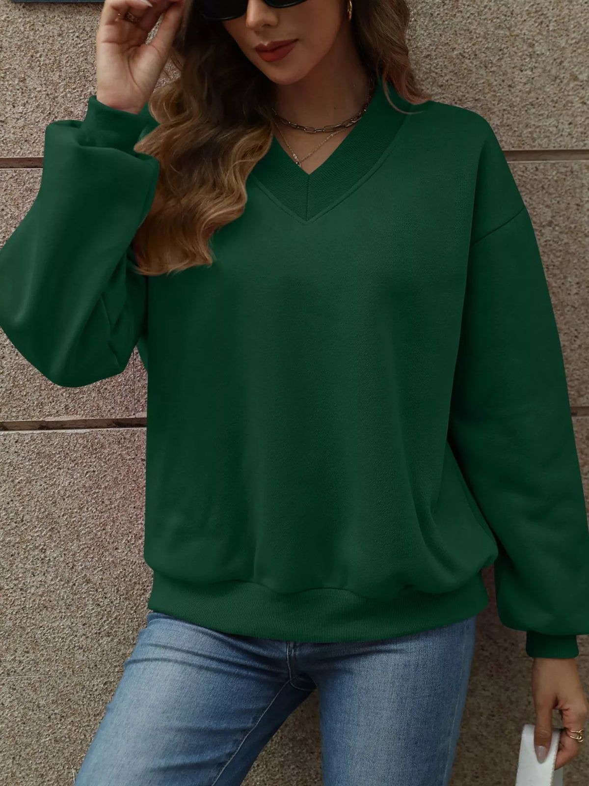 V-neck solid color casual sweatshirt by Trendsi, showing a comfortable fit and soft fabric in a neutral shade.