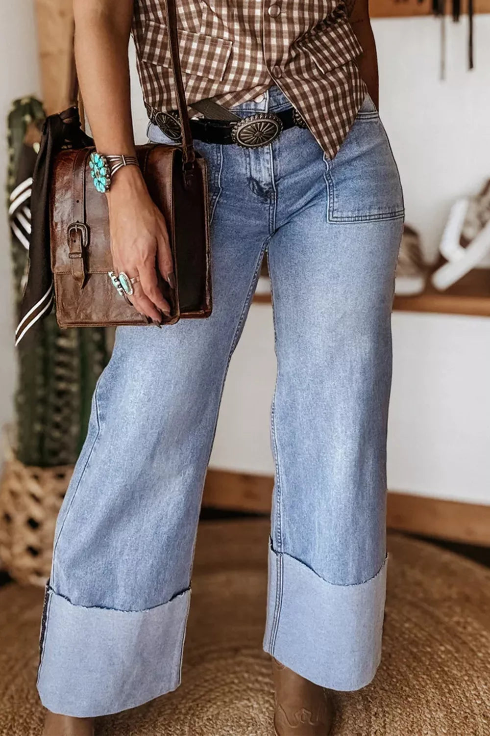 Loose blue jeans with turn-up cuffs from Plush Fashion Hub, displayed on a hanger against a neutral background.
