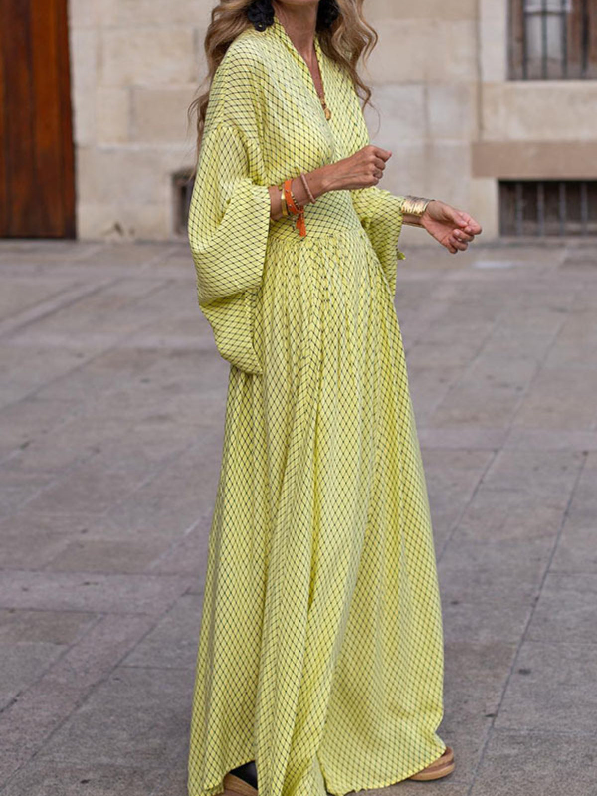 Elegant V-neck maxi dress with flowy sleeves by Trendsi, showcased on a model in a stylish, flowing design.