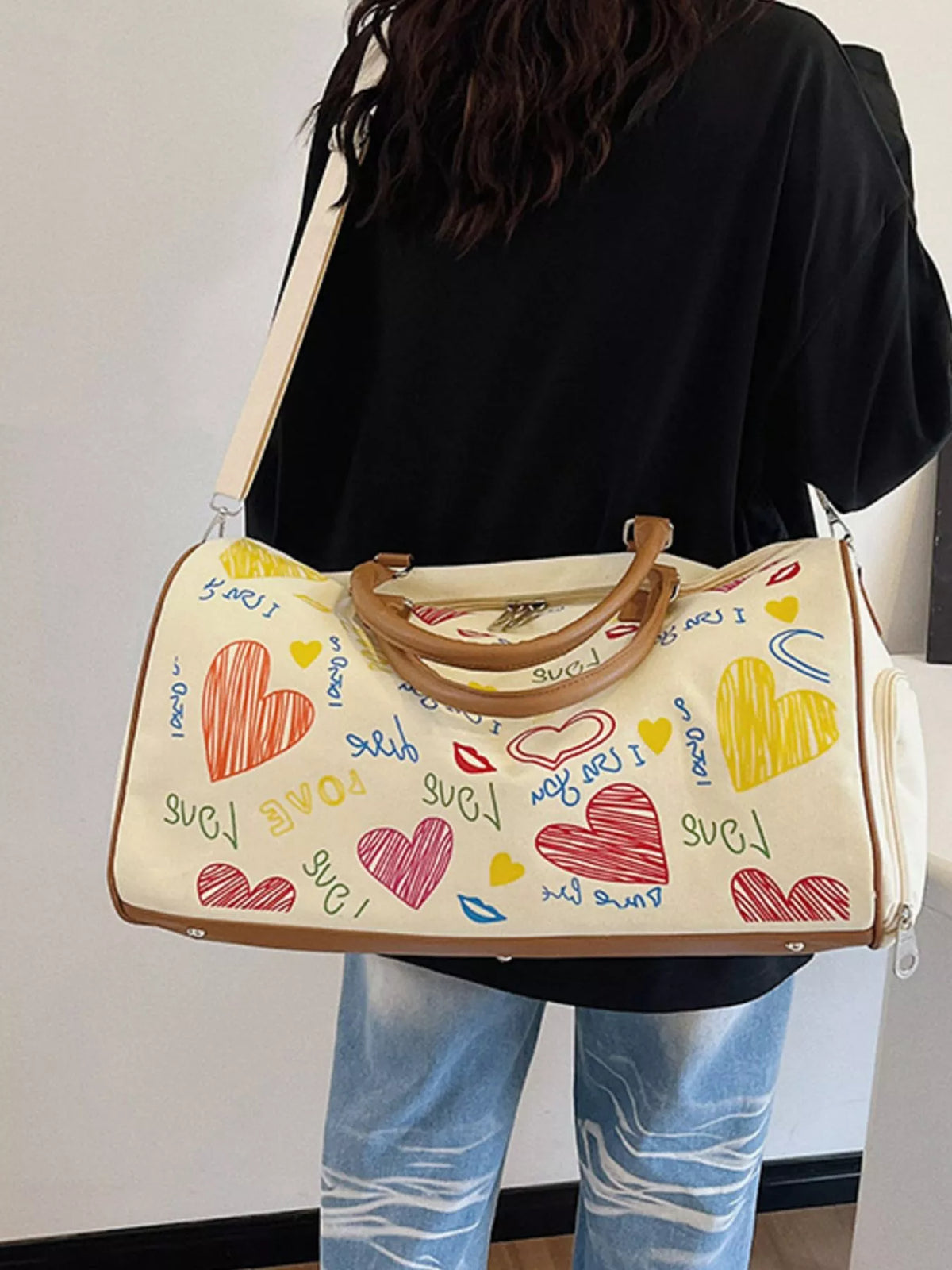Plush Fashion Hub printed duffel bag with adjustable strap, stylish travel bag with colorful pattern and sturdy handles.