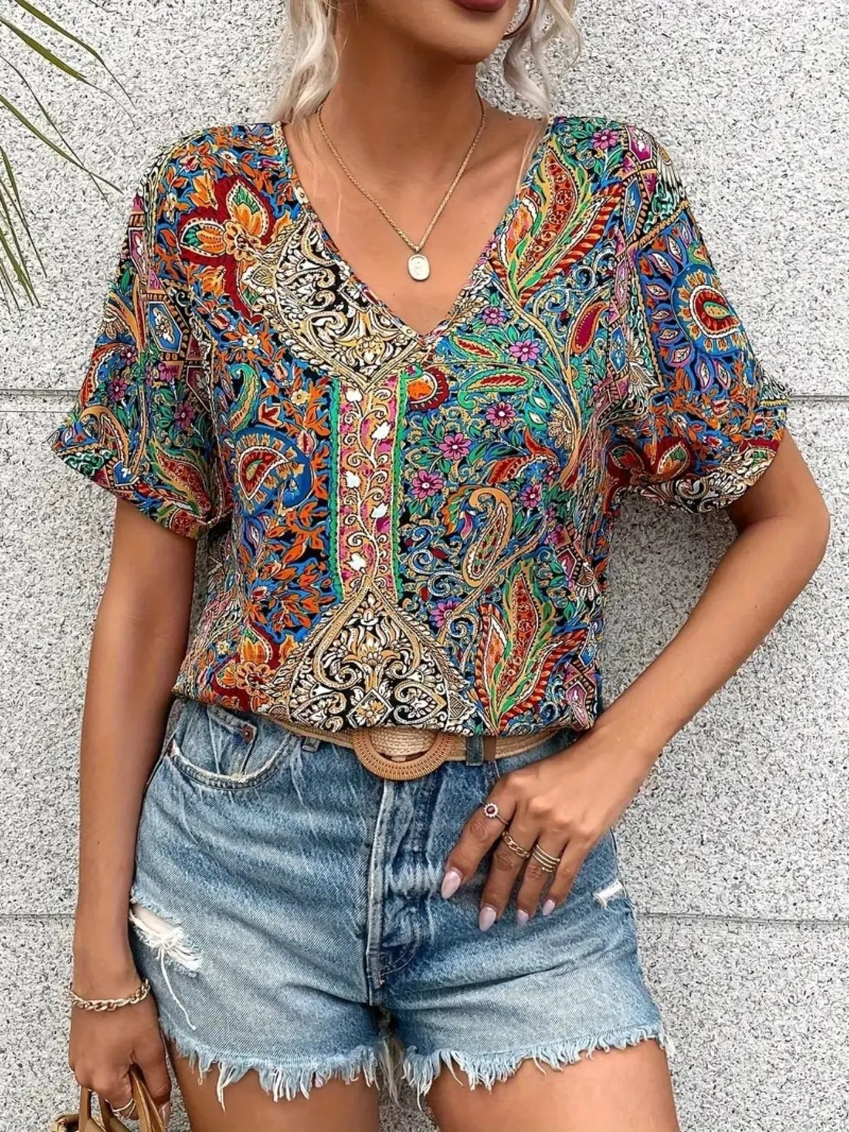 Plush Fashion Hub bohemian paisley V-neck short sleeve T-shirt with vibrant pattern and relaxed fit, displayed on a plain background.