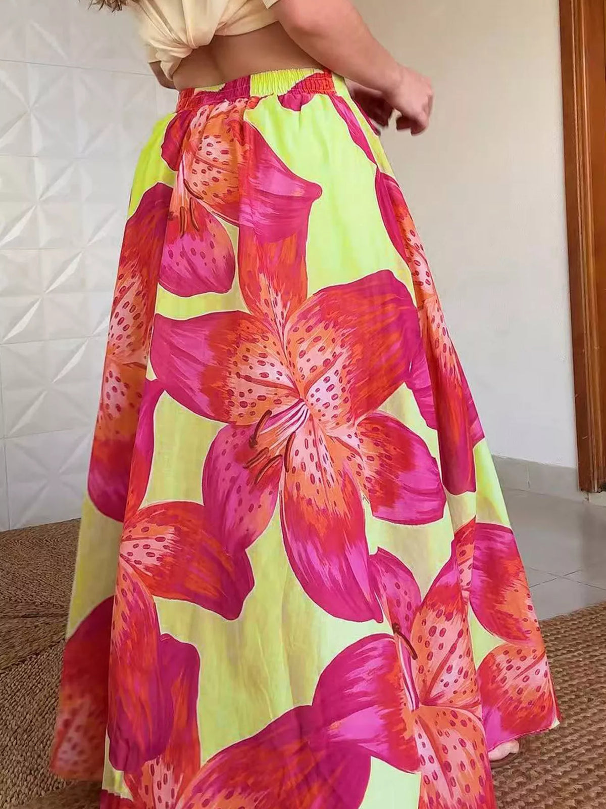 Women's lightweight boho floral print flowy maxi skirt with pockets by Plush Fashion Hub, showcasing its relaxed fit and vibrant pattern.