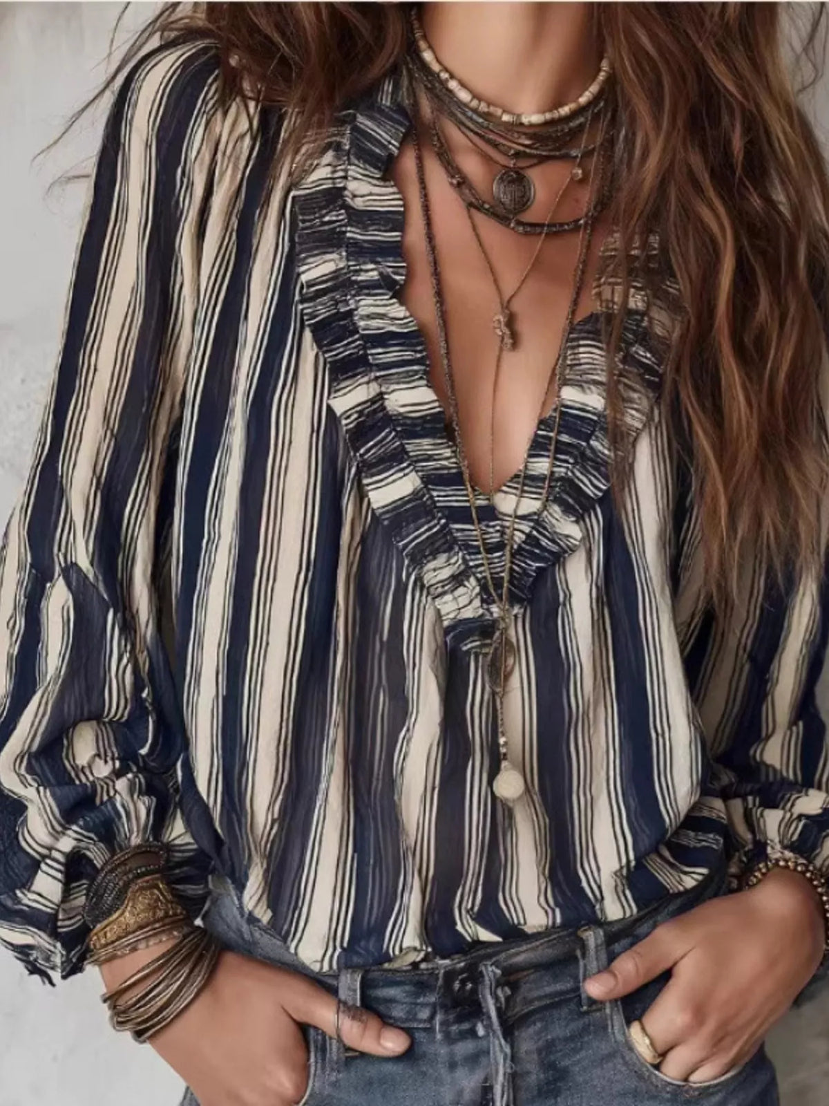 Striped balloon sleeve blouse for women by Trendsi, featuring a stylish design with bold stripes and voluminous sleeves.