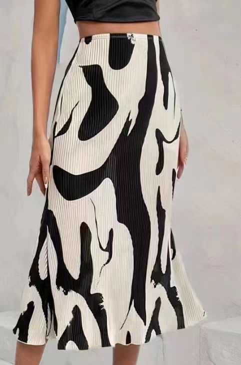 Women's zebra print pleated casual skirt with irregular hem and side slit, by FitiqueFit, shown on a model.