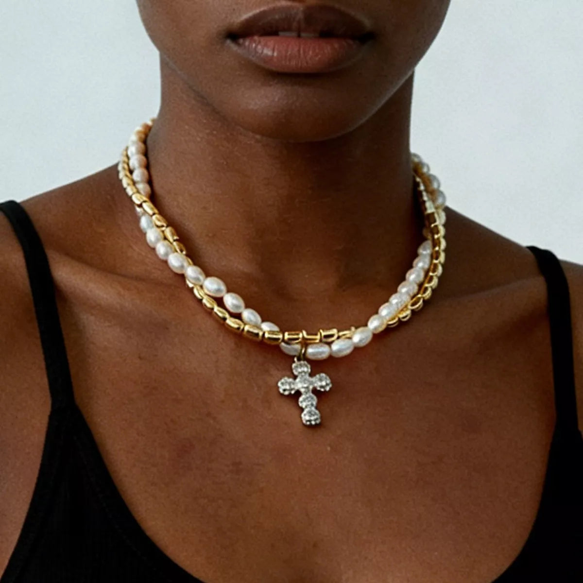 Elegant pearl alloy necklace with rhinestone cross pendant, featuring a delicate chain and sparkling detail, perfect for stylish jewelry.