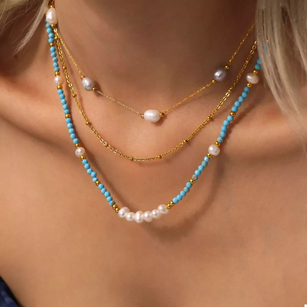 Turquoise pearl beaded necklace by Plush Fashion Hub featuring a string of vibrant turquoise pearls on a delicate necklace.