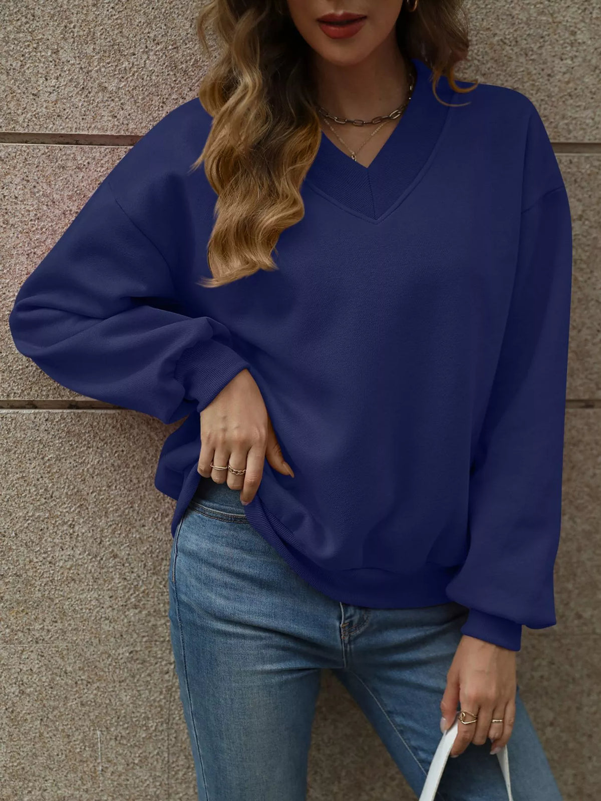 V-neck solid color casual sweatshirt by Trendsi, showing a comfortable fit and soft fabric in a relaxed style.