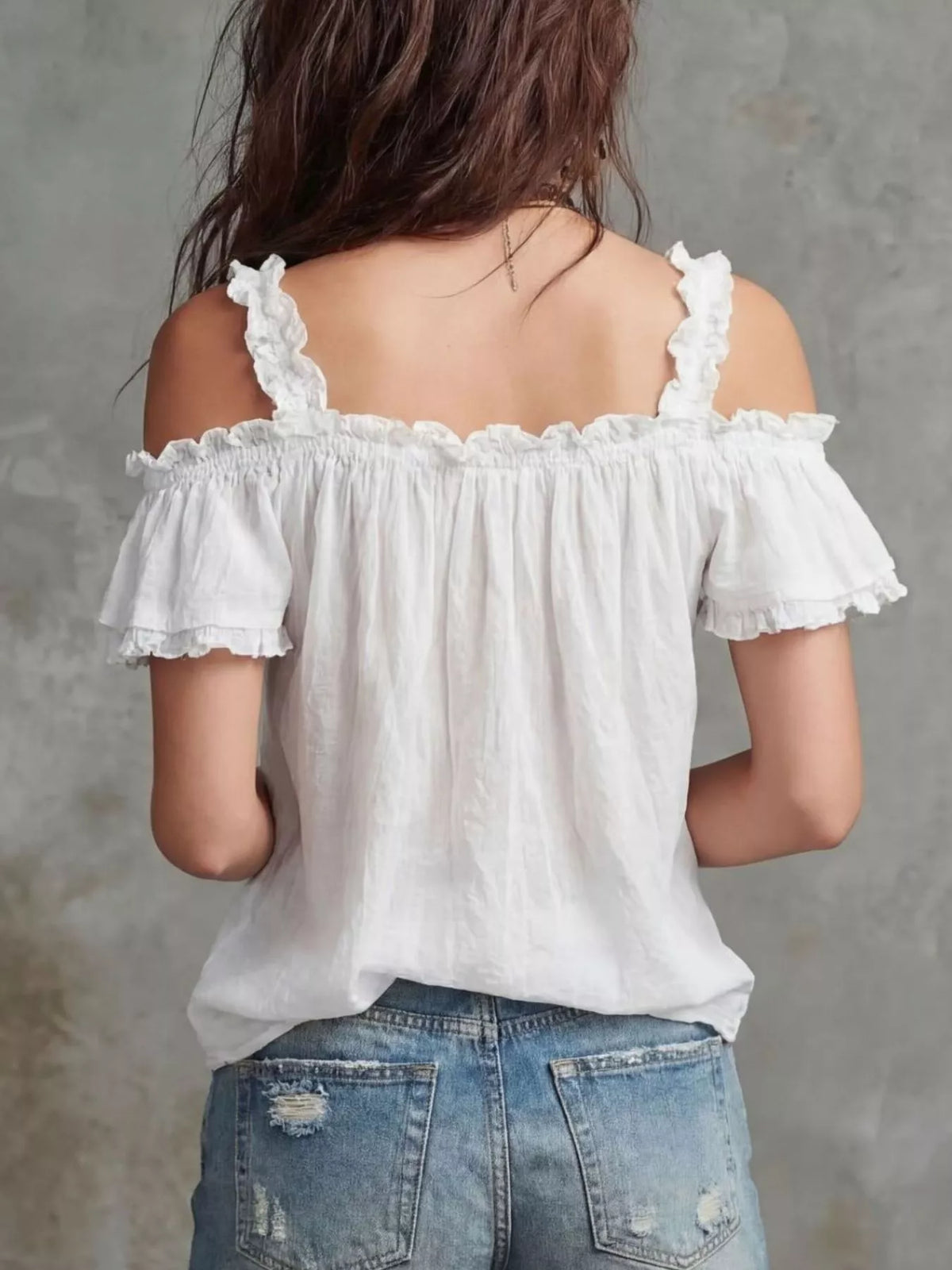 Plush Fashion Hub frill cold shoulder blouse with ruffled sleeves and lightweight fabric, displayed on a hanger.