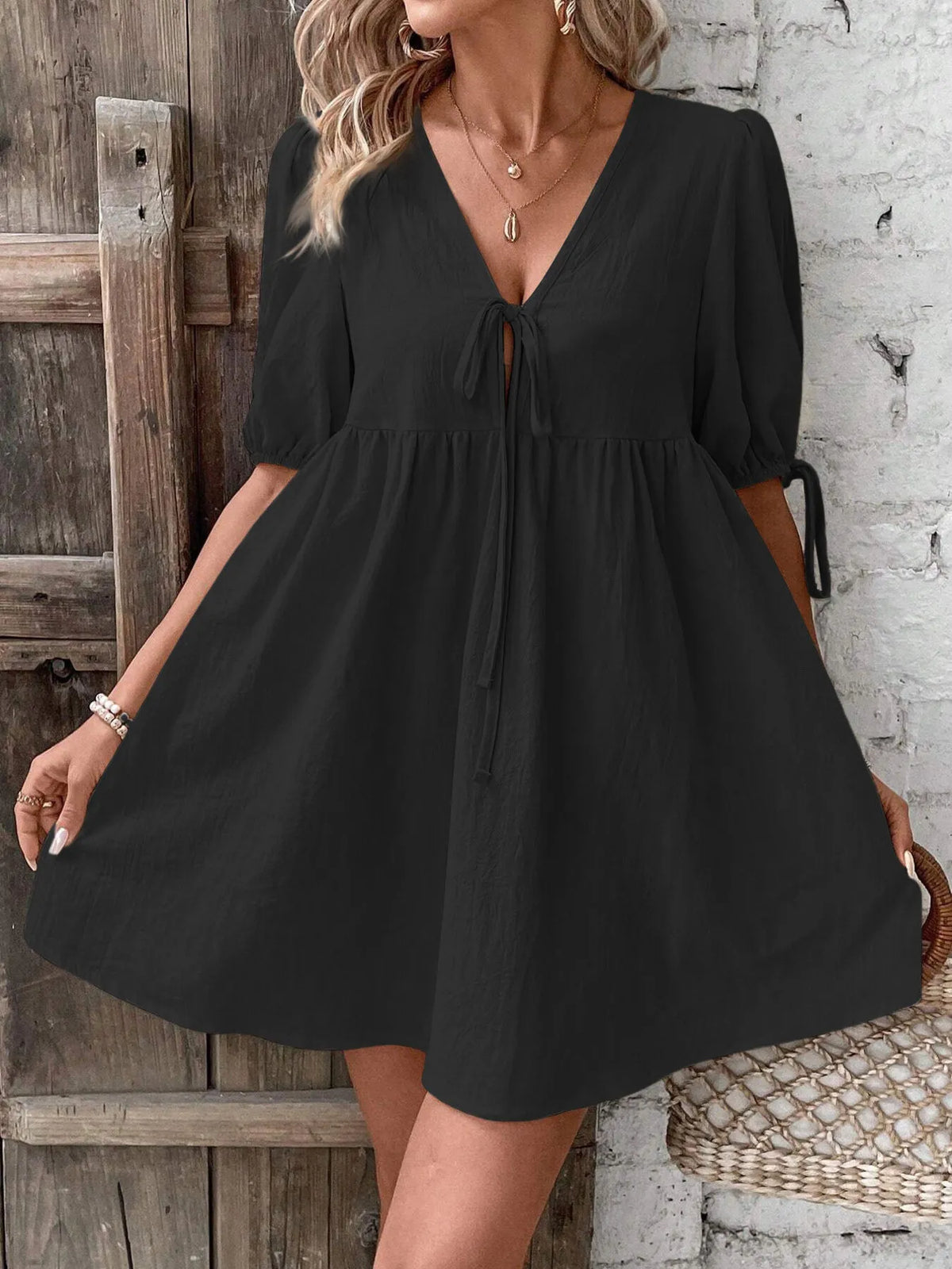 Cotton V-neck tie-front mini dress with puff sleeves by Plush Fashion Hub, featuring a stylish and feminine design.
