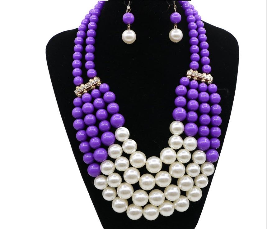 Multi Simulated Pearl Bohemian Jewelry Set with purple beads and faux pearls on a black bust.