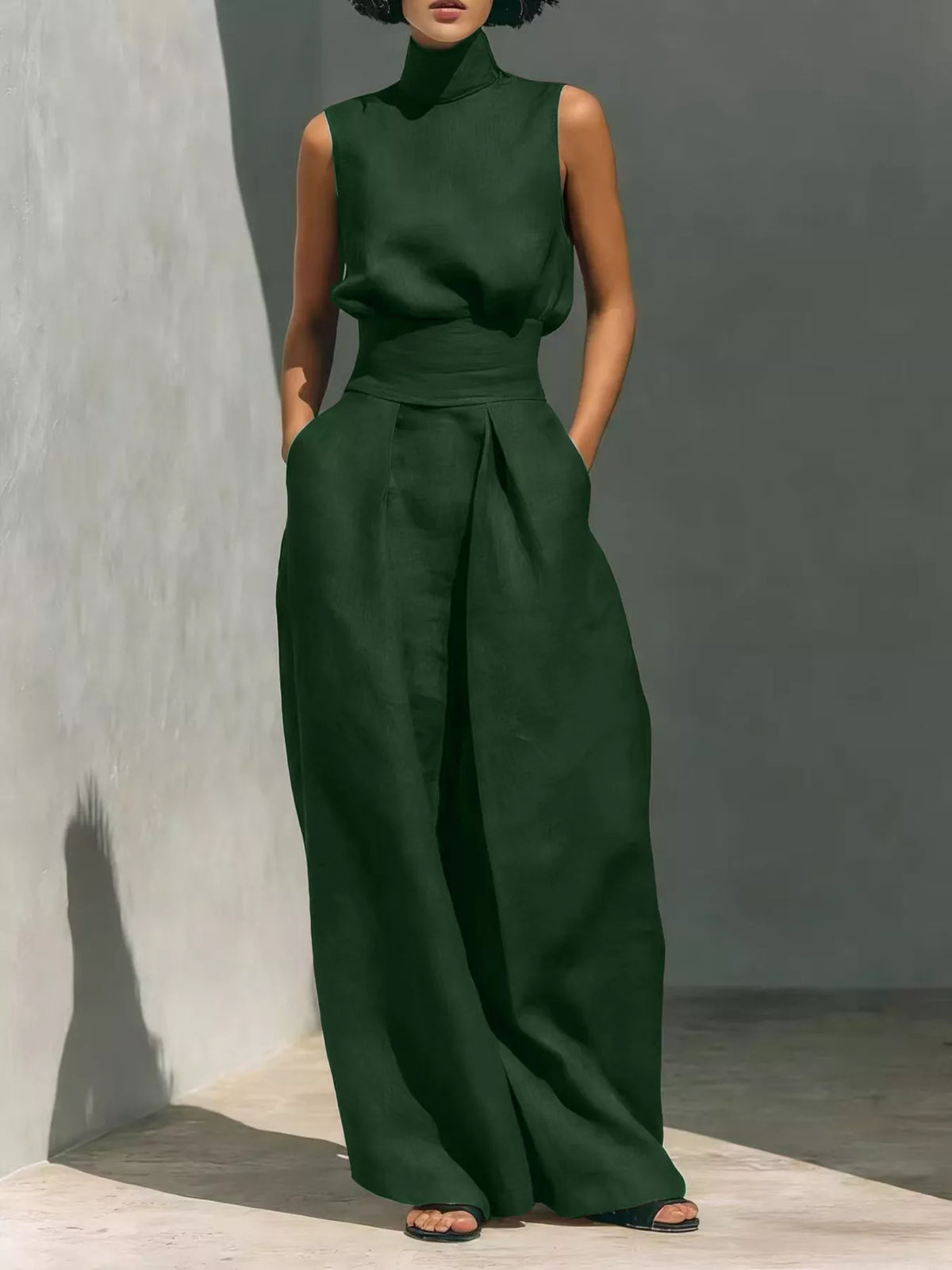Plus size full-length sleeveless wide-leg jumpsuit with smocked waist by Trendsi, shown in a natural pose.