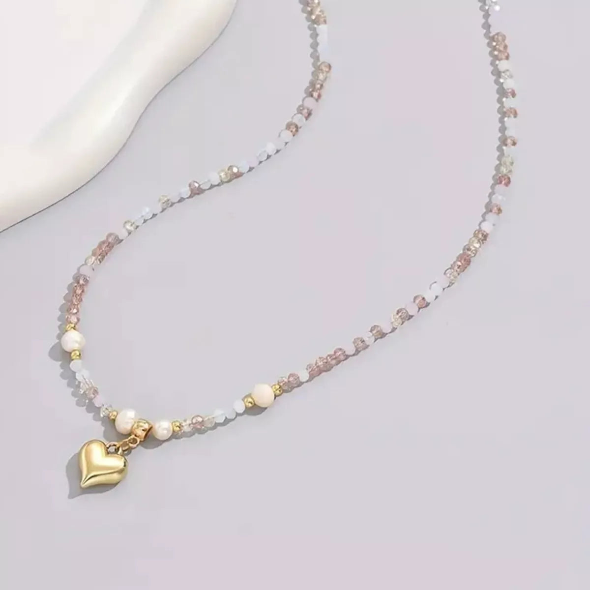 Bead heart pendant necklace by Plush Fashion Hub featuring a delicate heart-shaped bead design on a stylish chain.
