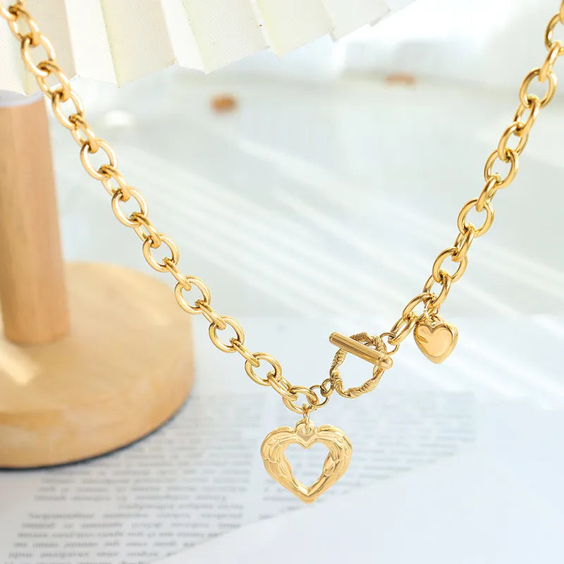 Titanium steel heart pendant necklace with a polished finish, stylish jewelry piece from Plush Fashion Hub.