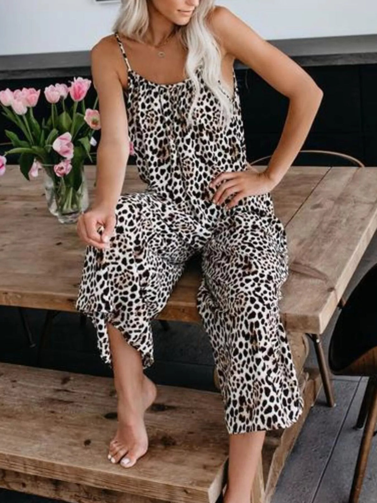 Plus size tie-dye wide leg jumpsuit by Plush Fashion Hub, full-length with relaxed fit and vibrant colorful pattern.