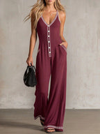 Women's V-neck backless wide-leg jumpsuit by FitiqueFit, high waist casualwear, shown in a stylish, flowing silhouette.