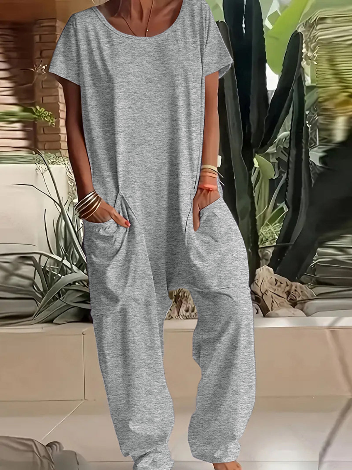 Plus size loose fit V-neck short sleeve jumpsuit with wide legs, stylish and comfortable from Trendsi.