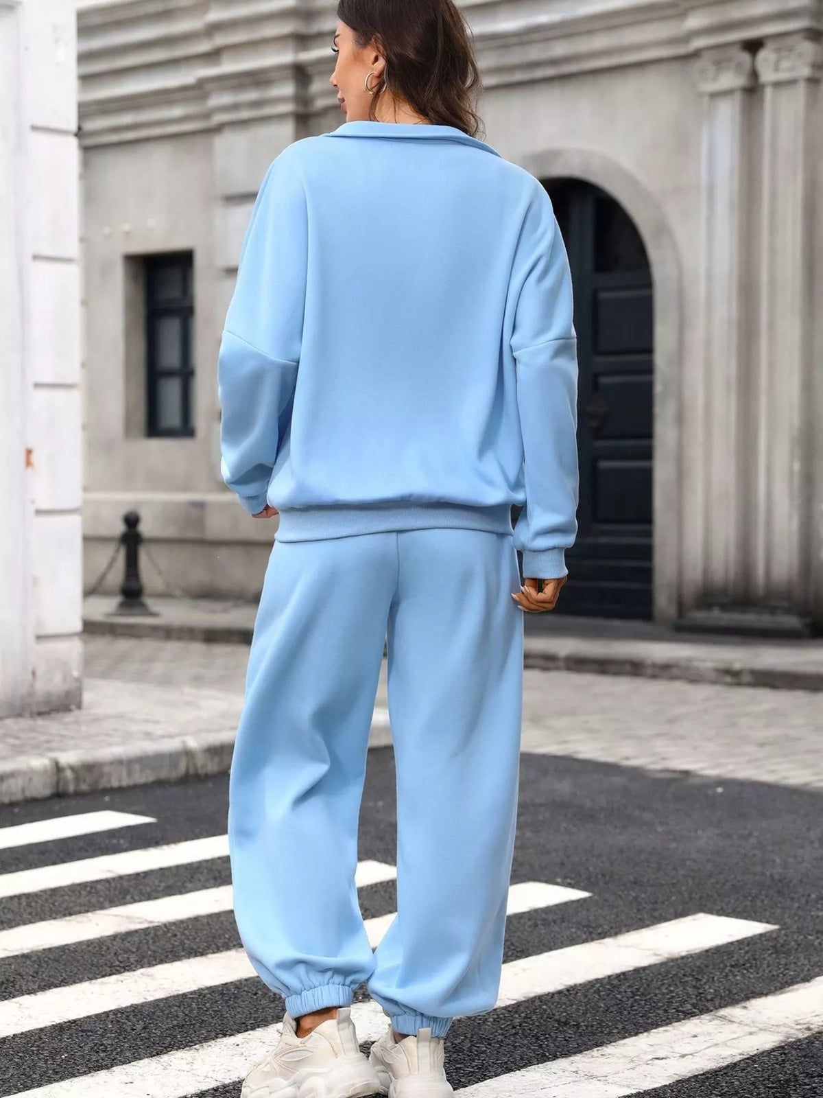 Women's zip-up long sleeve top and pants set by Trendsi, casual loungewear with a comfortable fit in soft fabric.