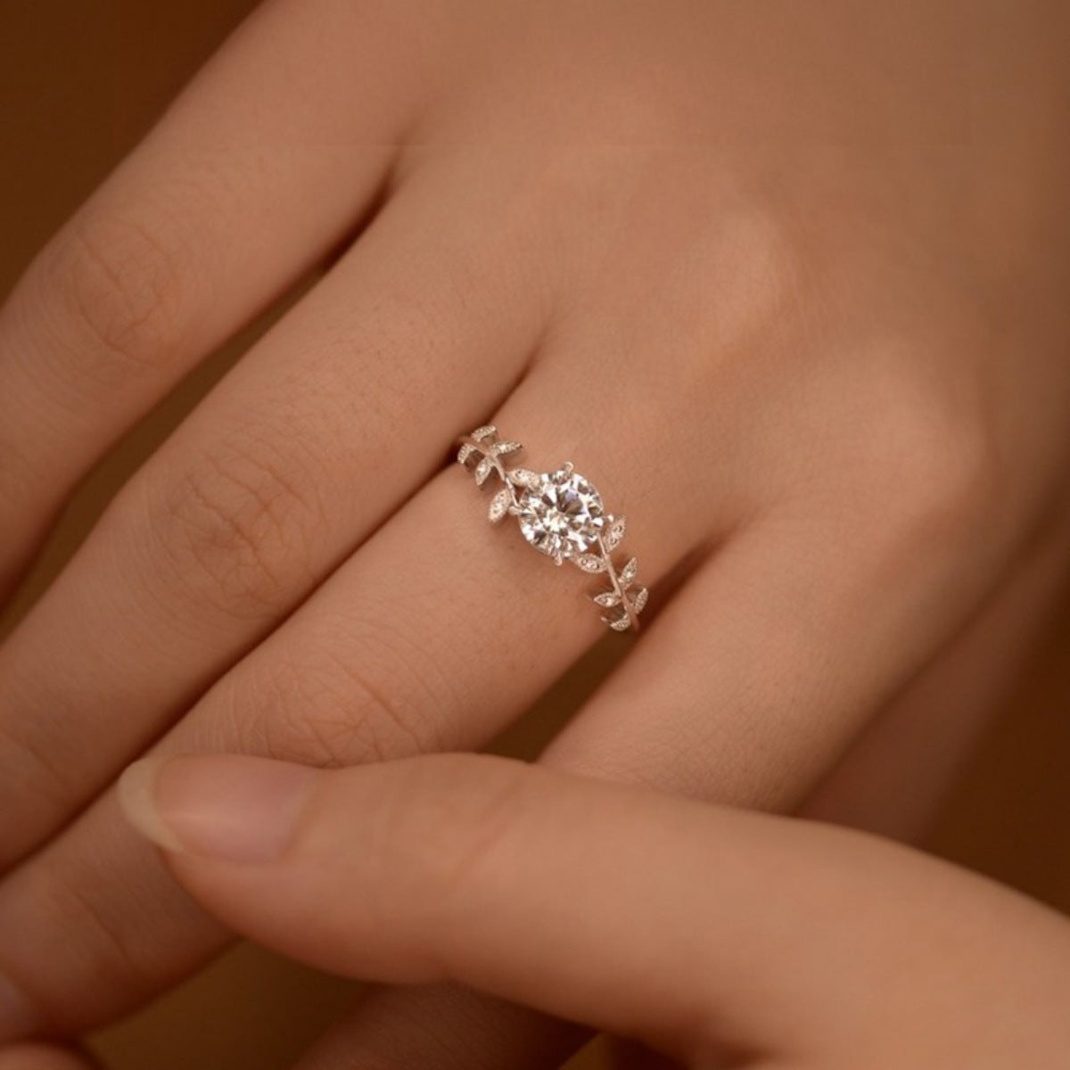 Sterling silver leaf ring with 1 carat moissanite gemstone, elegant jewelry piece by Plush Fashion Hub.