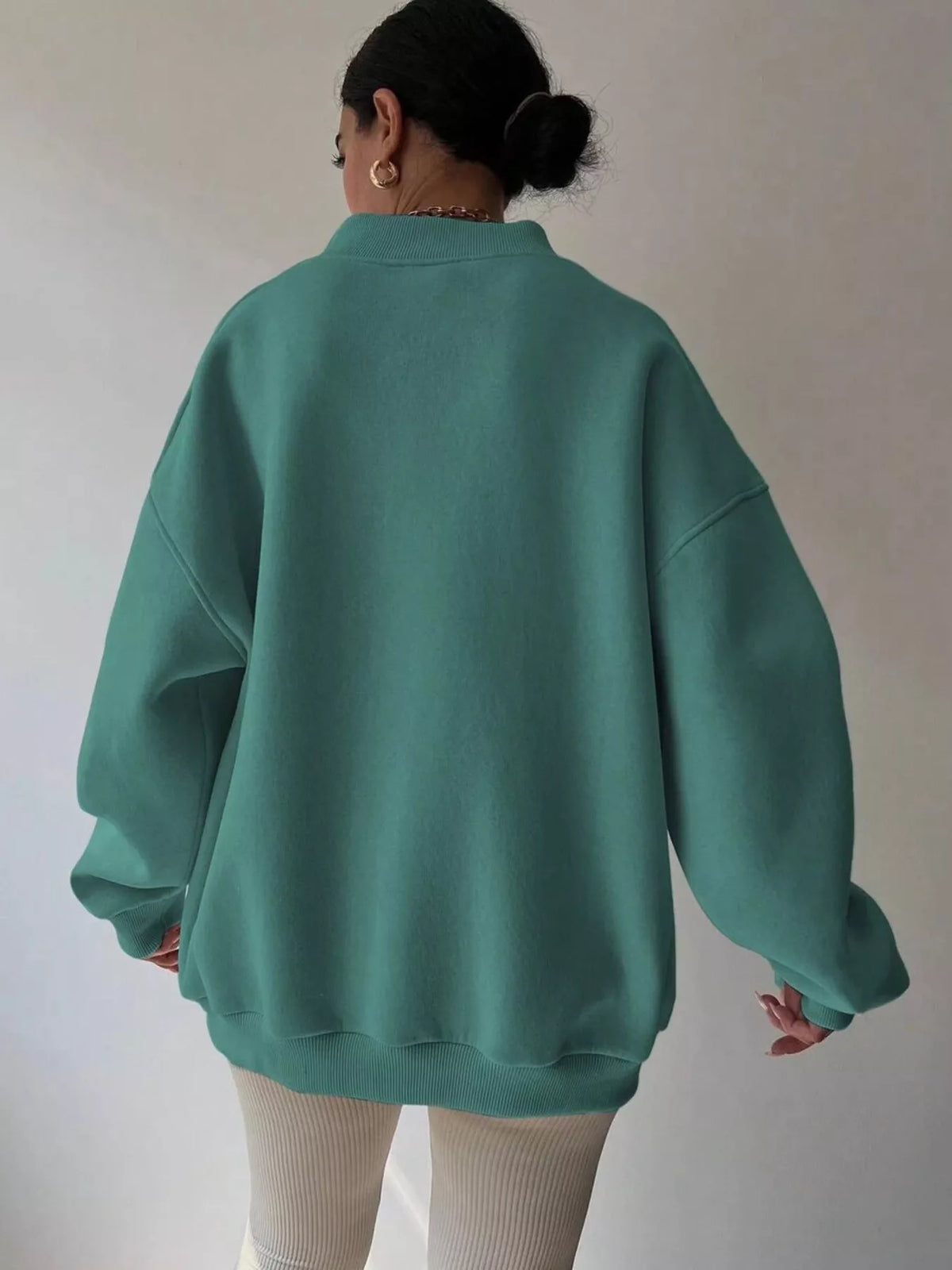 Oversized dropped shoulder long sleeve sweatshirt from Trendsi, featuring a relaxed fit and casual style in soft fabric.