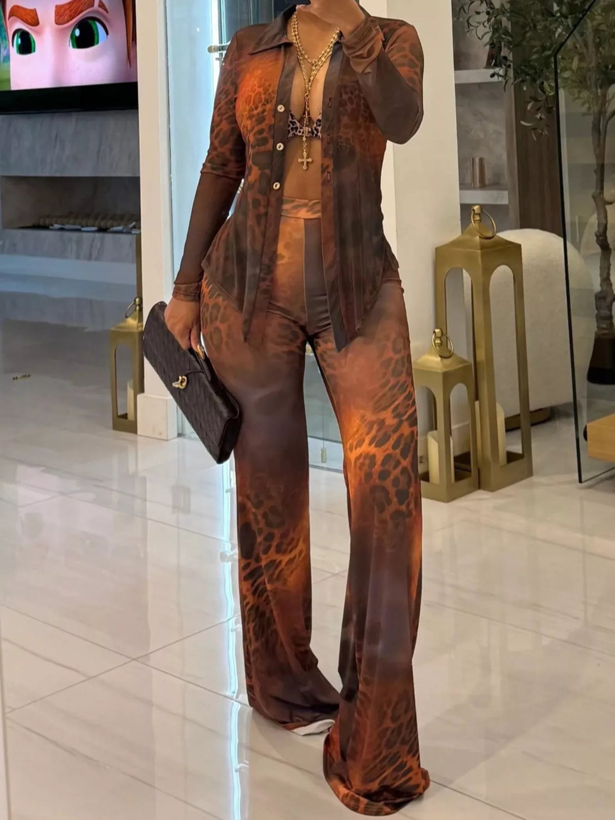 Printed mesh shirt and pants set for women by Trendsi, featuring a stylish, breathable mesh fabric in a coordinated ensemble.