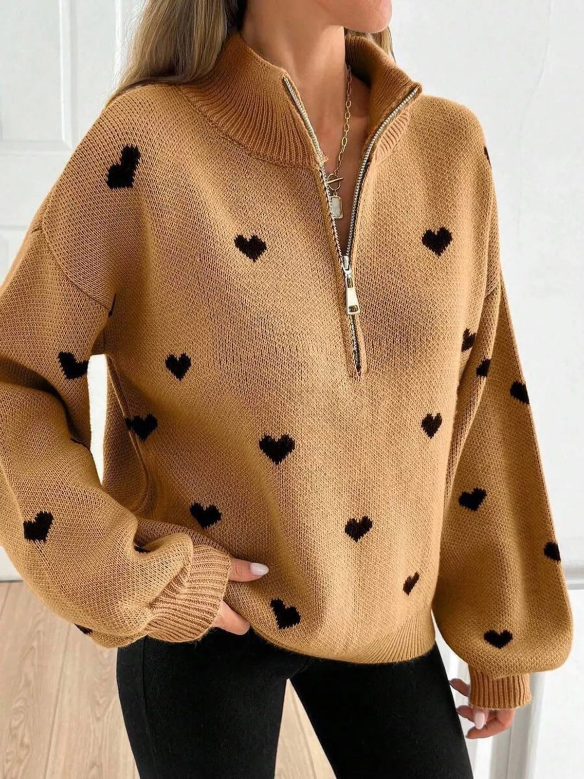 Plus size full heart half-zip long sleeve sweater by Trendsi, featuring a cozy knit design and a large heart pattern.