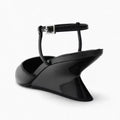Elegant black patent leather wedge sandals with a sleek architectural heel and an adjustable ankle strap.