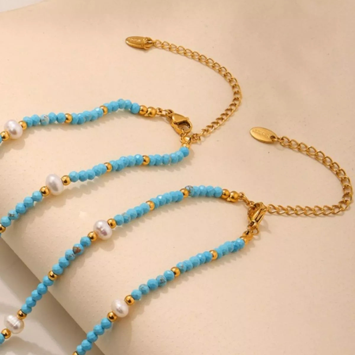 Turquoise pearl beaded necklace by Plush Fashion Hub featuring vibrant blue beads and elegant design.