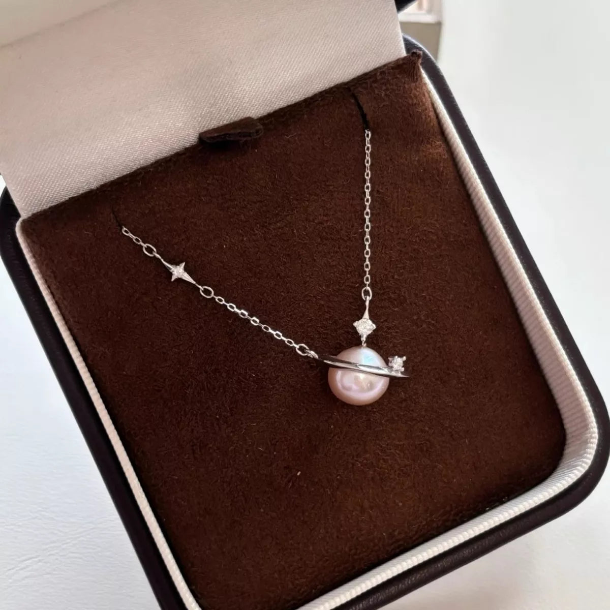 Plush Fashion Hub Planet Pearl Pendant Necklace featuring a spherical pearl charm on a delicate chain.