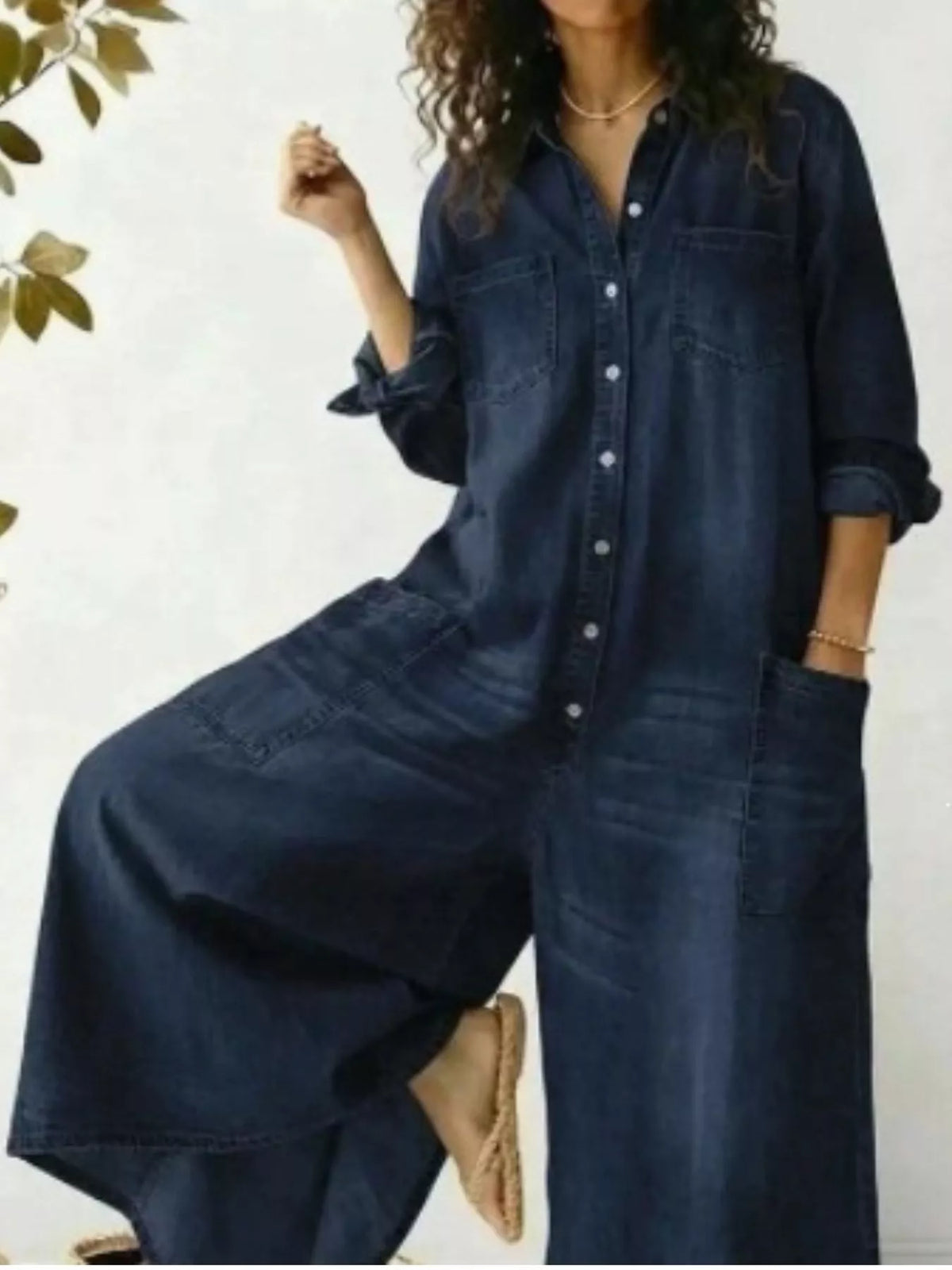 Plus size full button-front wide leg jumpsuit with chest pockets, trendy and comfortable by Trendsi, shown on a model.