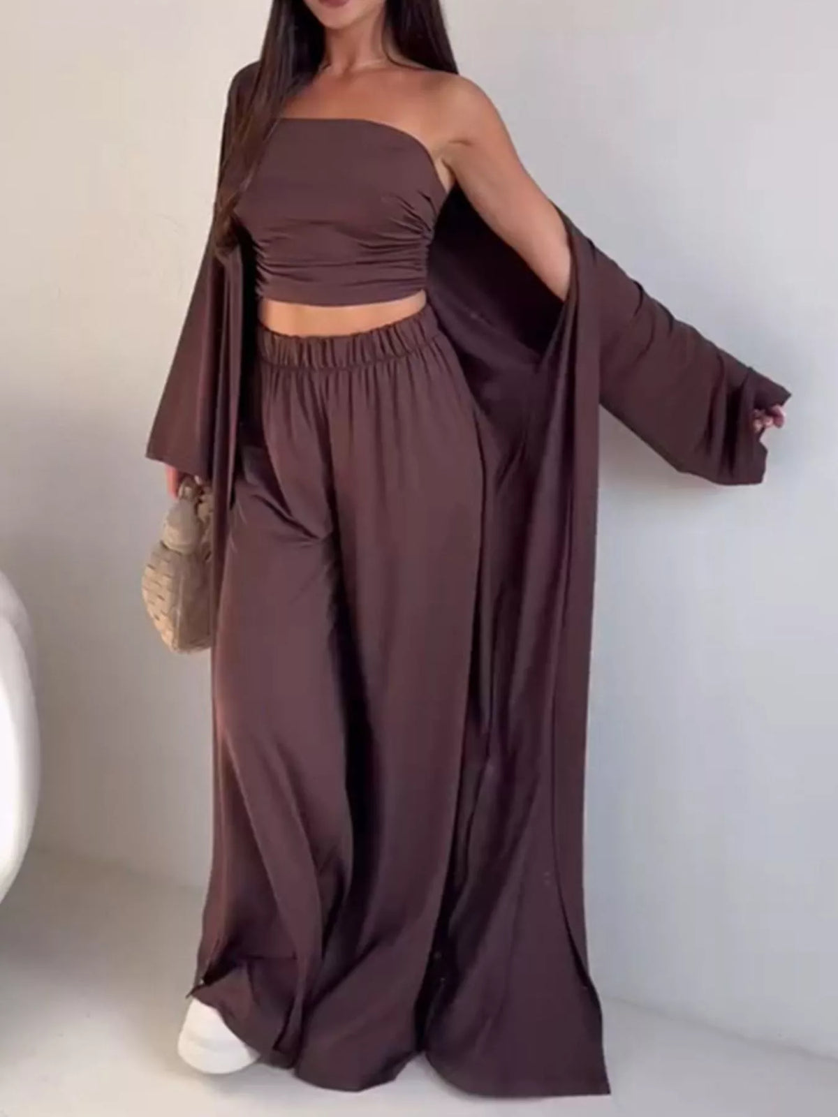 Trendsi chic 3-piece set with strapless ruched crop top, wide-leg pants, and matching cardigan displayed on a model.
