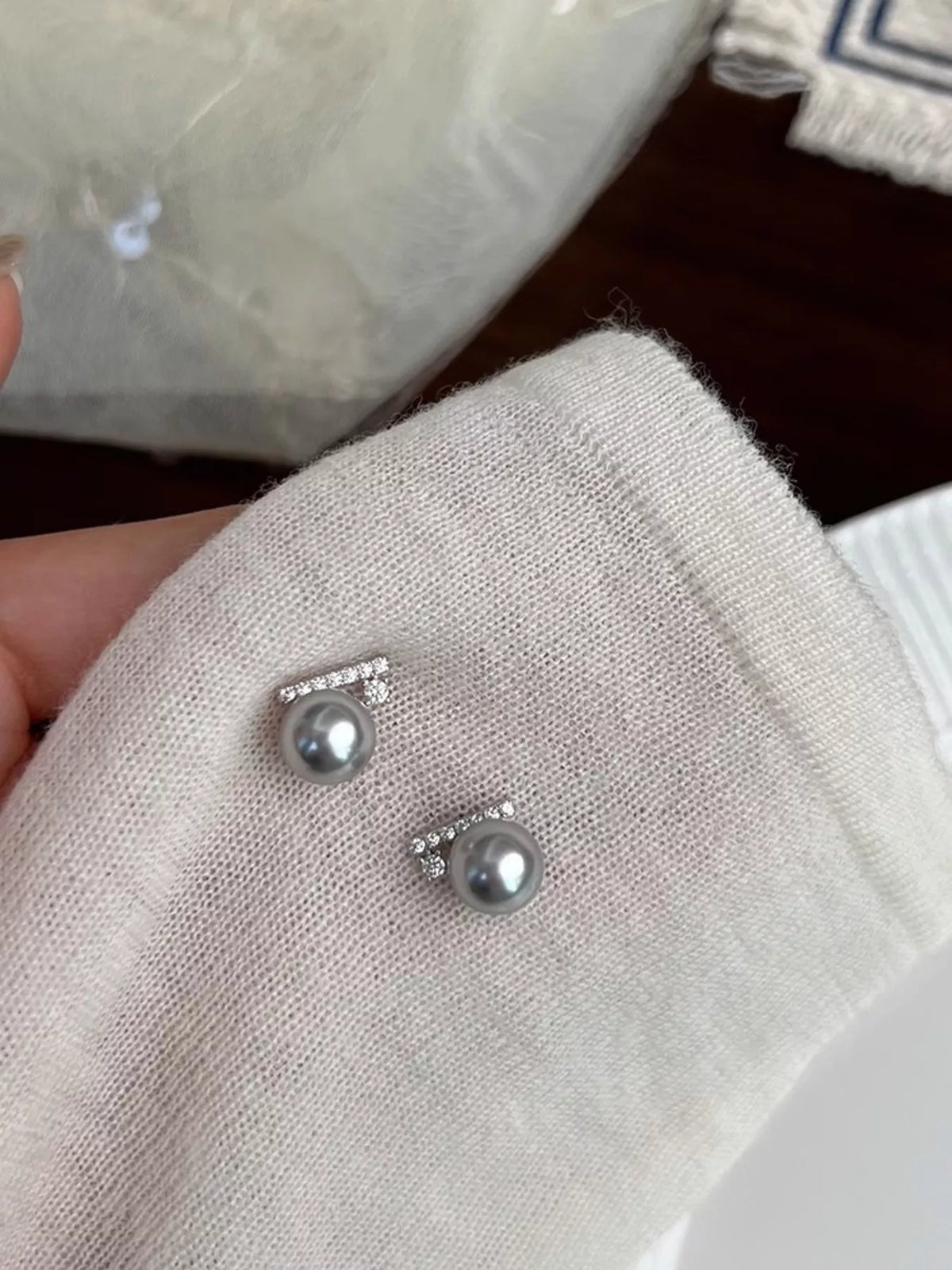 Close-up of zircon and pearl stud earrings from Plush Fashion Hub, showcasing sparkling stones and elegant pearl accents.