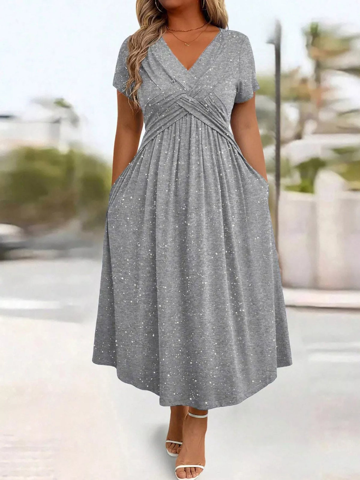 Plus size glitter flutter sleeve midi dress by Trendsi, showcasing a shimmering fabric and flowing silhouette.