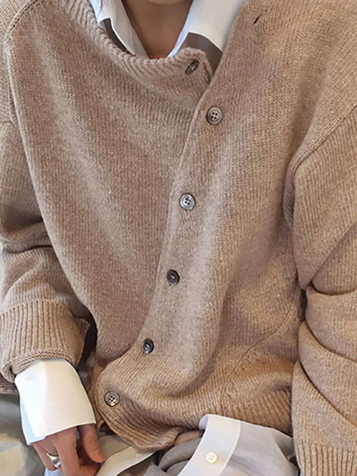 Asymmetric button-down sweater by Trendsi featuring a stylish, modern design with unique button details and soft knit fabric.