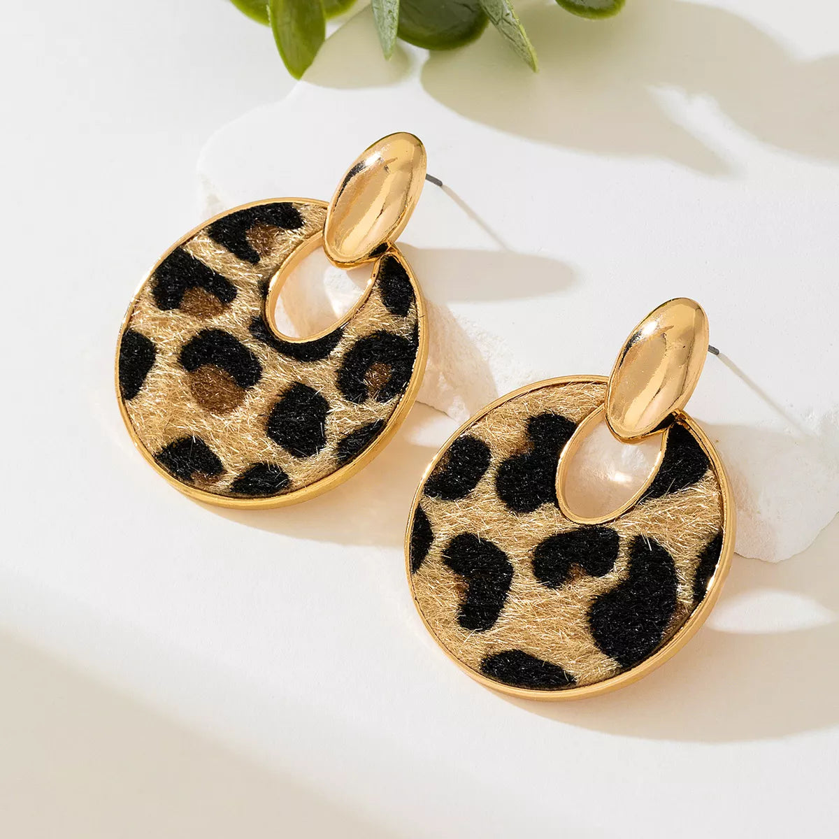 Leopard circle dangle earrings by Plush Fashion Hub featuring gold-tone hoops with leopard print accents.