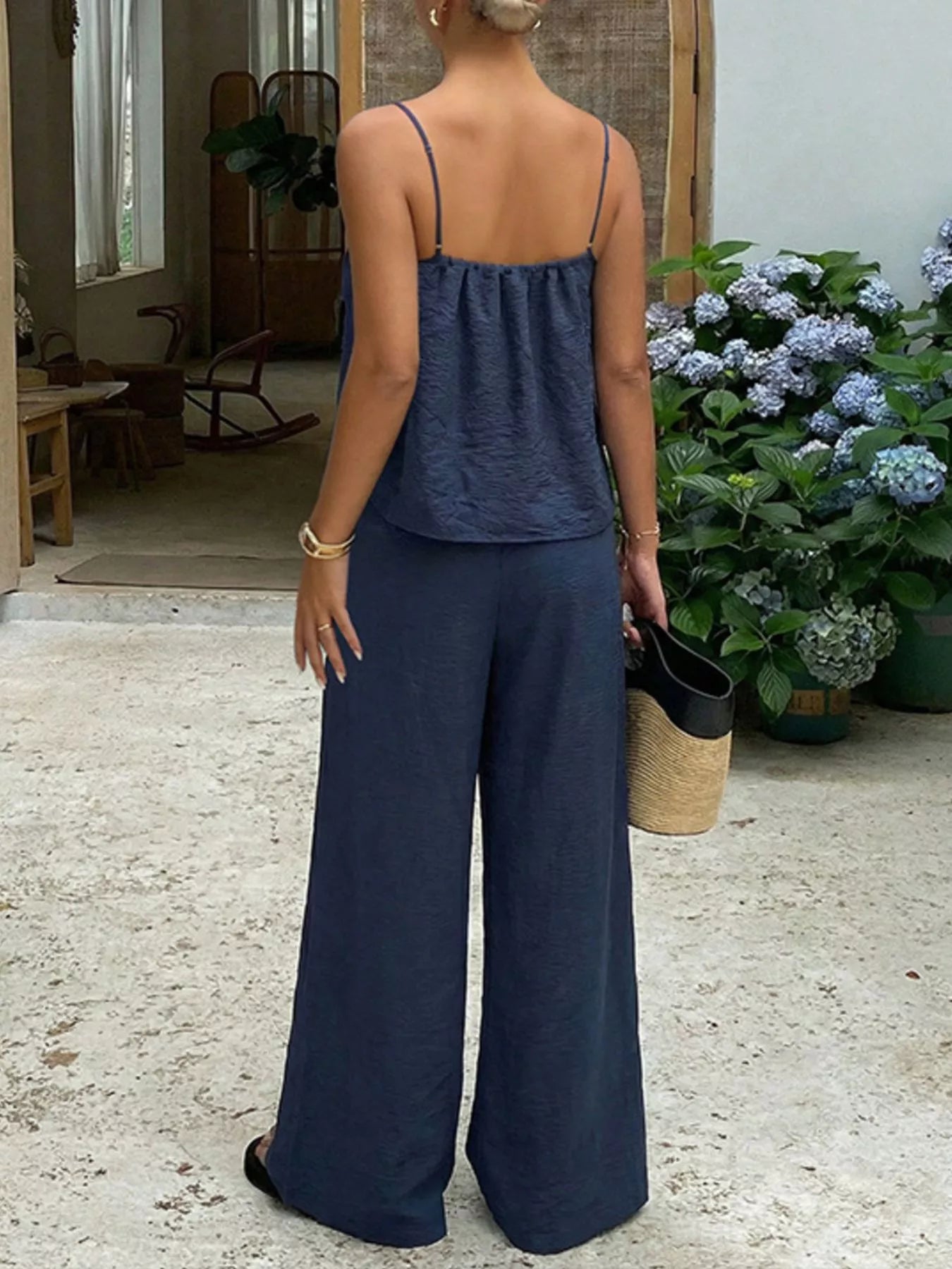 Lace trim camisole and wide-leg pants set by Trendsi, featuring delicate lace details and comfortable matching ensemble.