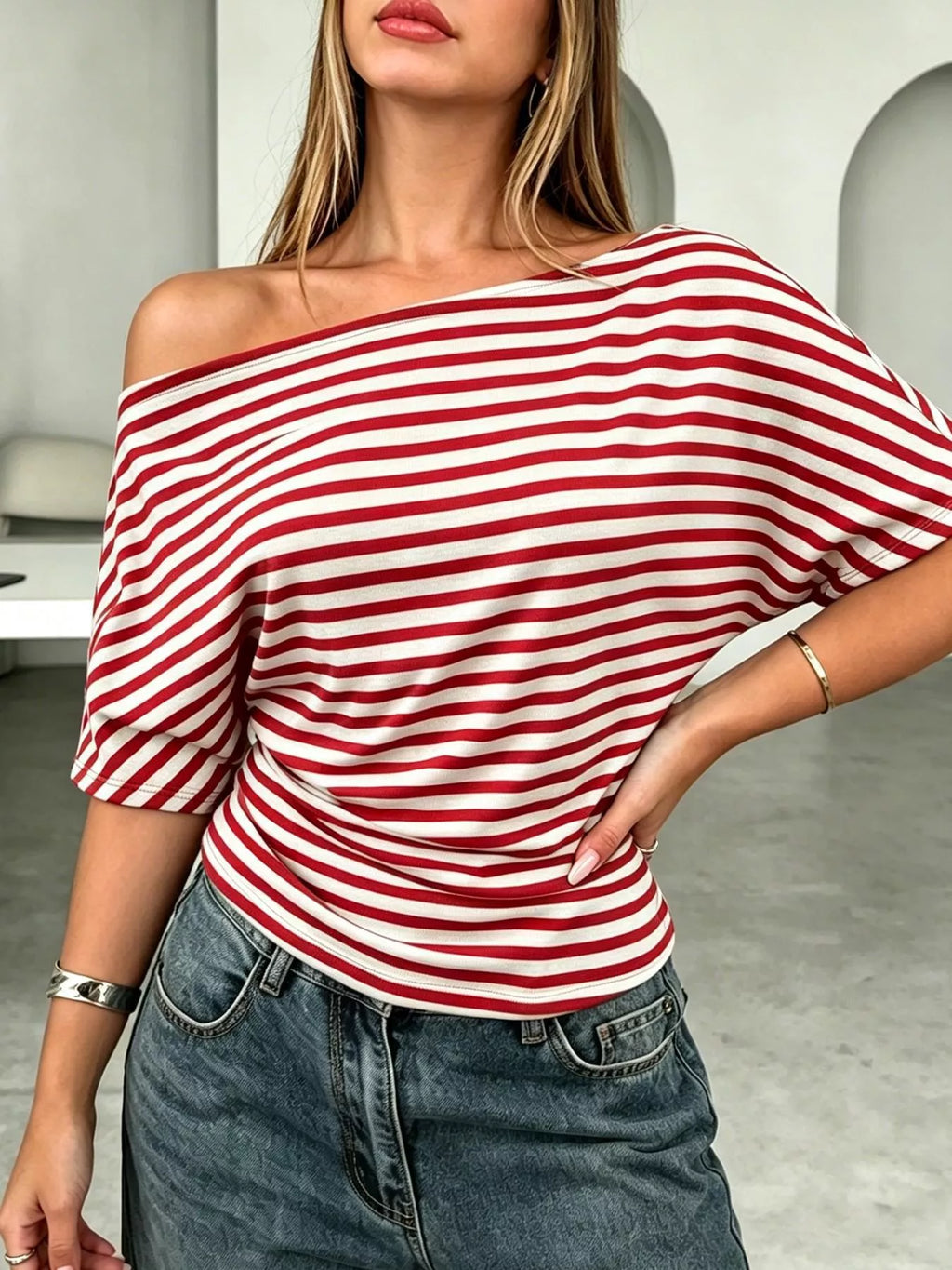 One shoulder striped dolman sleeve T-shirt from Trendsi, featuring a relaxed fit and bold horizontal stripes.