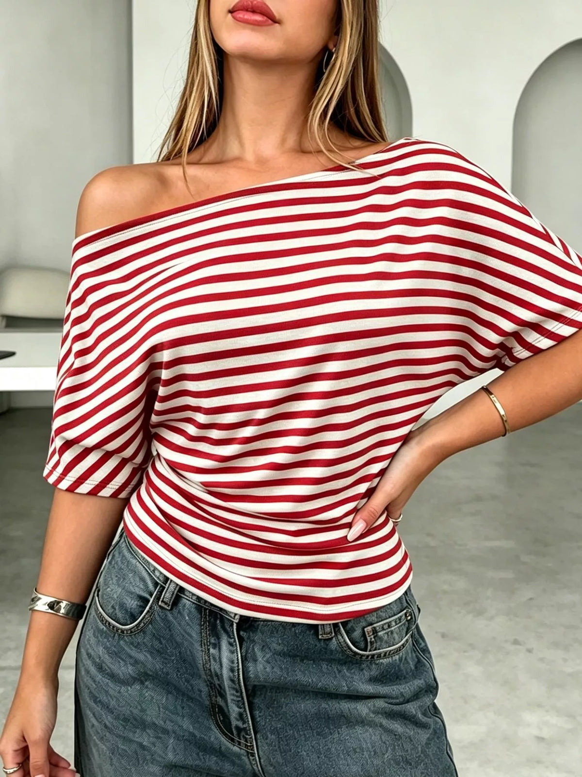 Striped one-shoulder dolman sleeve T-shirt by Plush Fashion Hub, featuring a stylish asymmetric design and casual fit.