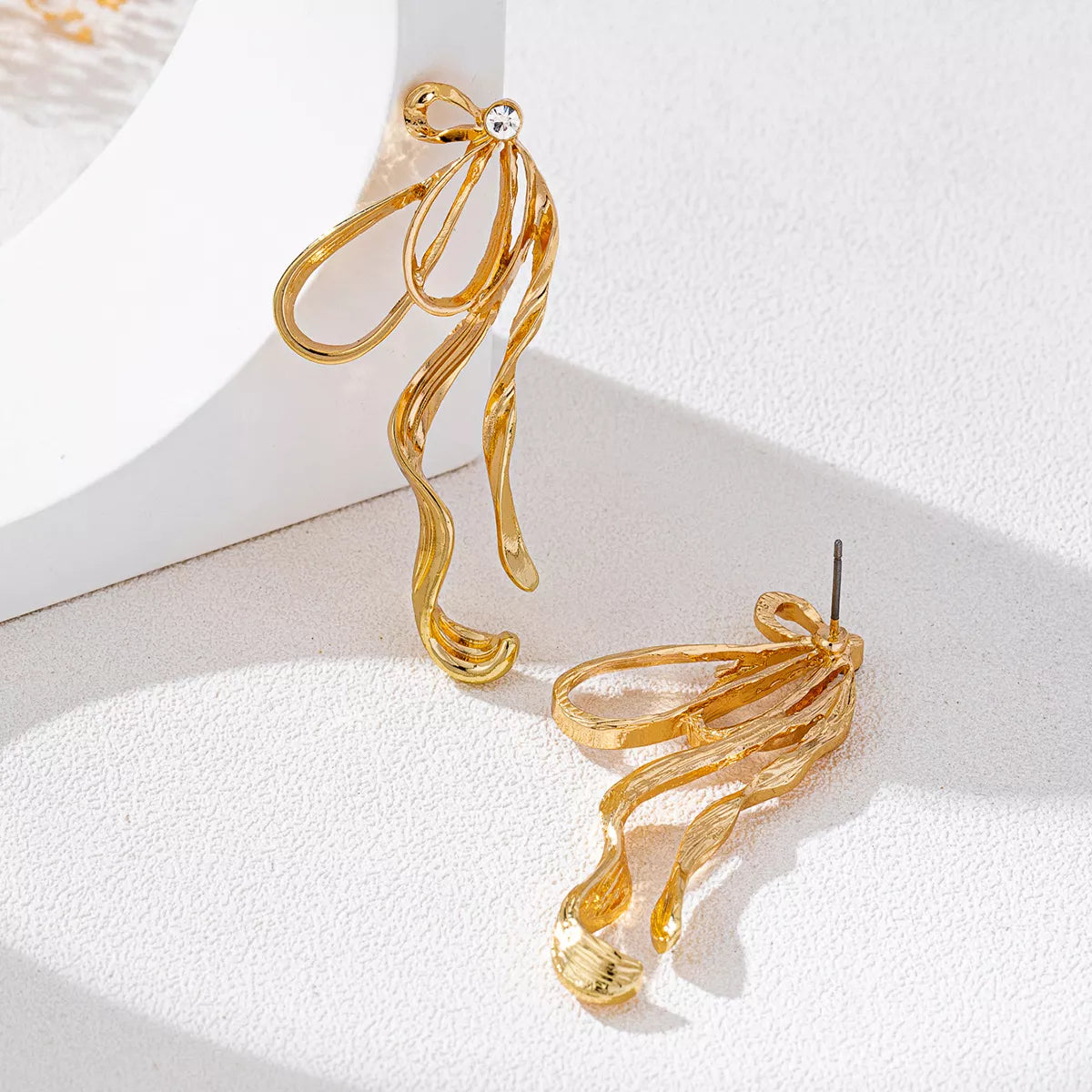 18K gold-plated bow earrings with delicate design, featuring shiny finish and stylish charm, perfect for elegant accessories.